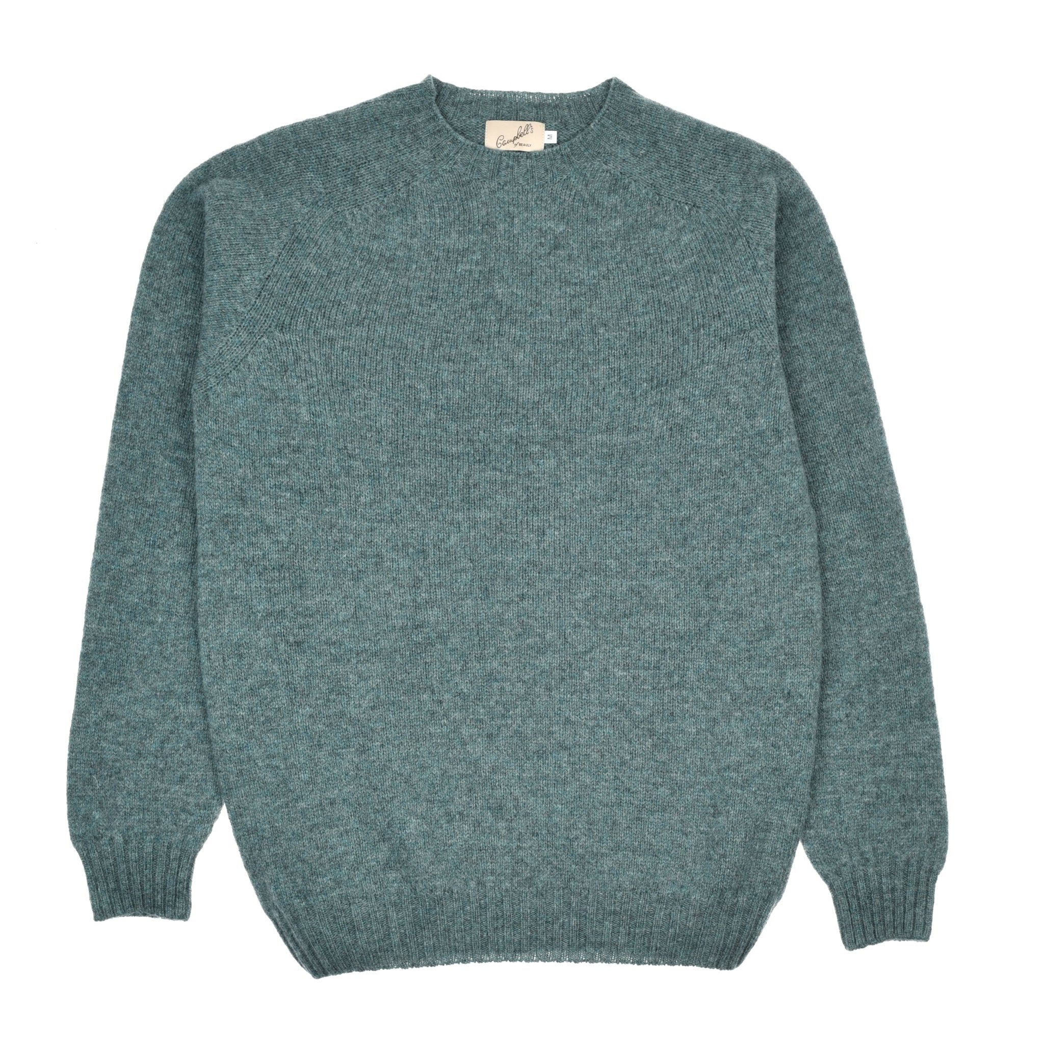 The Shetland Jumper by Campbell's of Beauly is a teal lambswool sweater with long sleeves, a crew neck, ribbed cuffs and hem—laid flat on white—timelessly inspired by classic Scottish knitwear.
