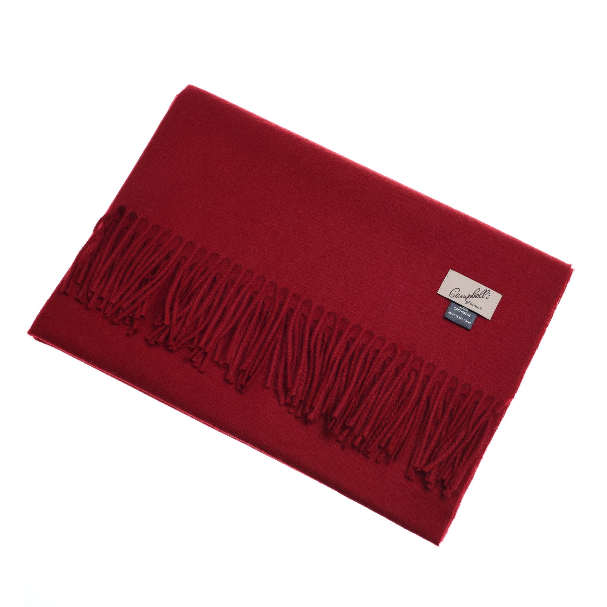 A folded red Campbell's of Beauly Cashmere Stole with fringed ends and two small fabric labels near the corner is shown on a white background.