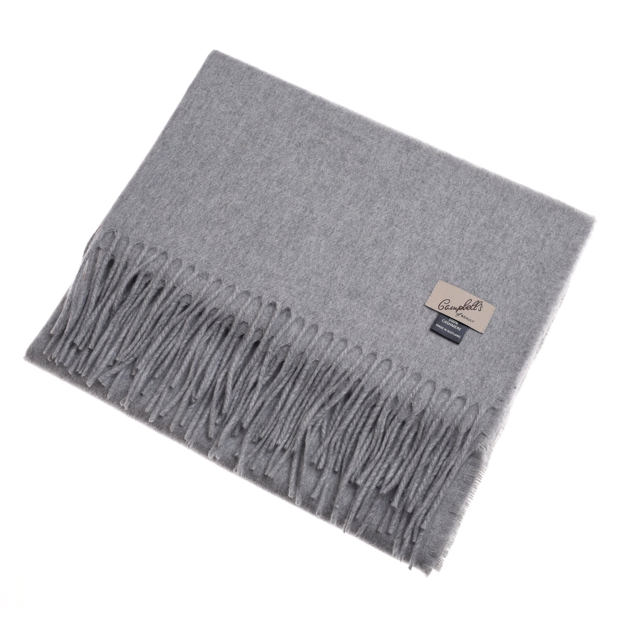 The Unisex Cashmere Scarf by Campbell's of Beauly, shown neatly folded in light gray with fringe and twin labels on a white background, is a luxurious accessory crafted from fine Scottish cashmere.