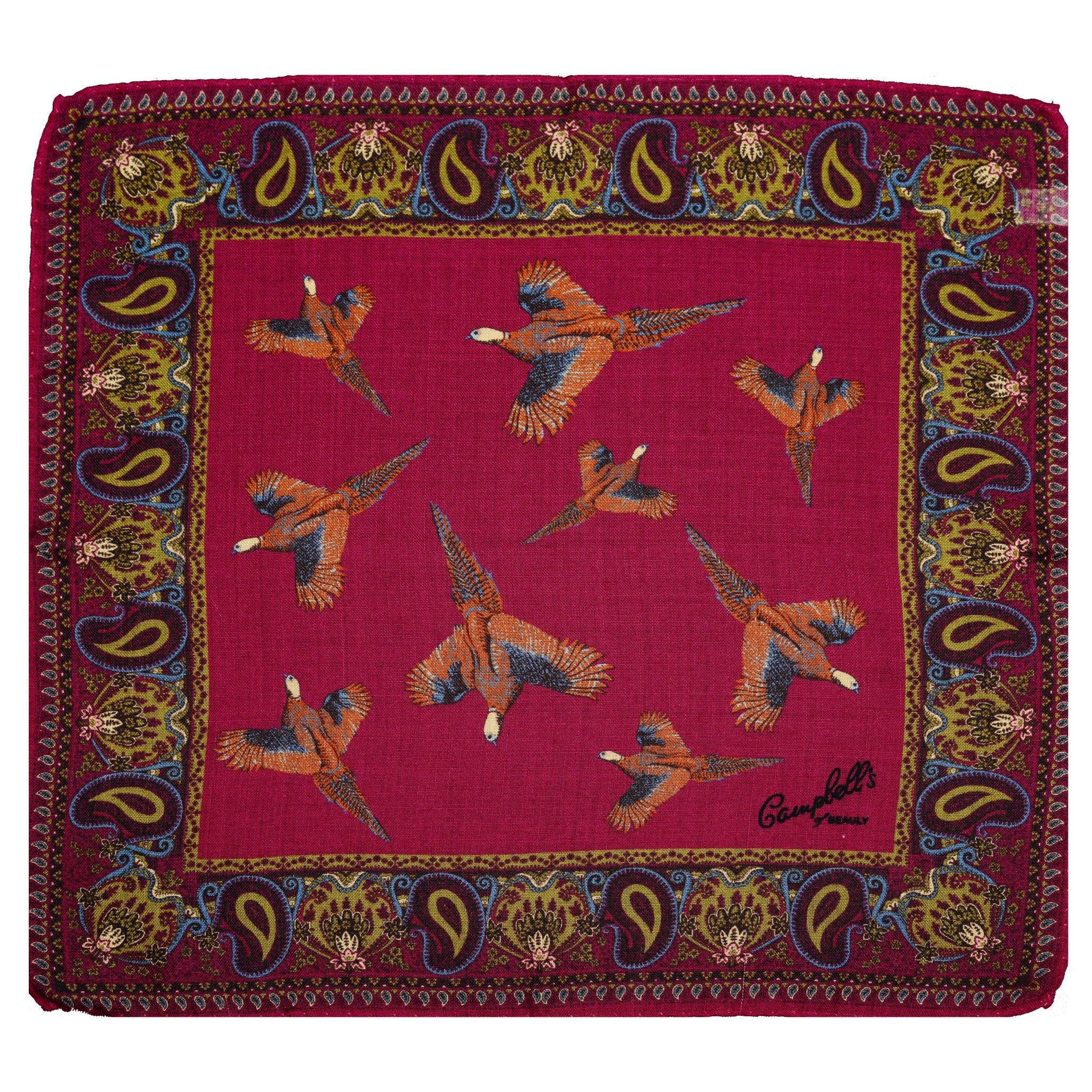 A luxurious olive Wool & Silk Scarf by Campbells of Beauly, featuring a paisley border, flying pheasants at the center, and a black script signature in one corner.