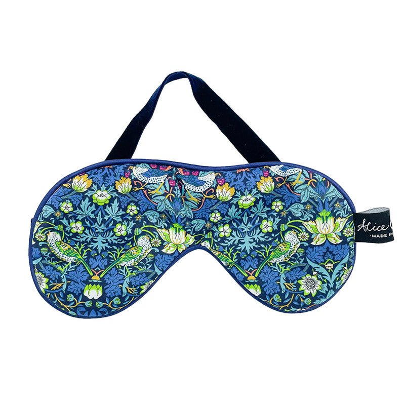 The Alice Caroline Liberty Print Eye Mask features a blue, green, and yellow floral and bird design with a soft black strap—a luxurious sleep mask for restful nights.