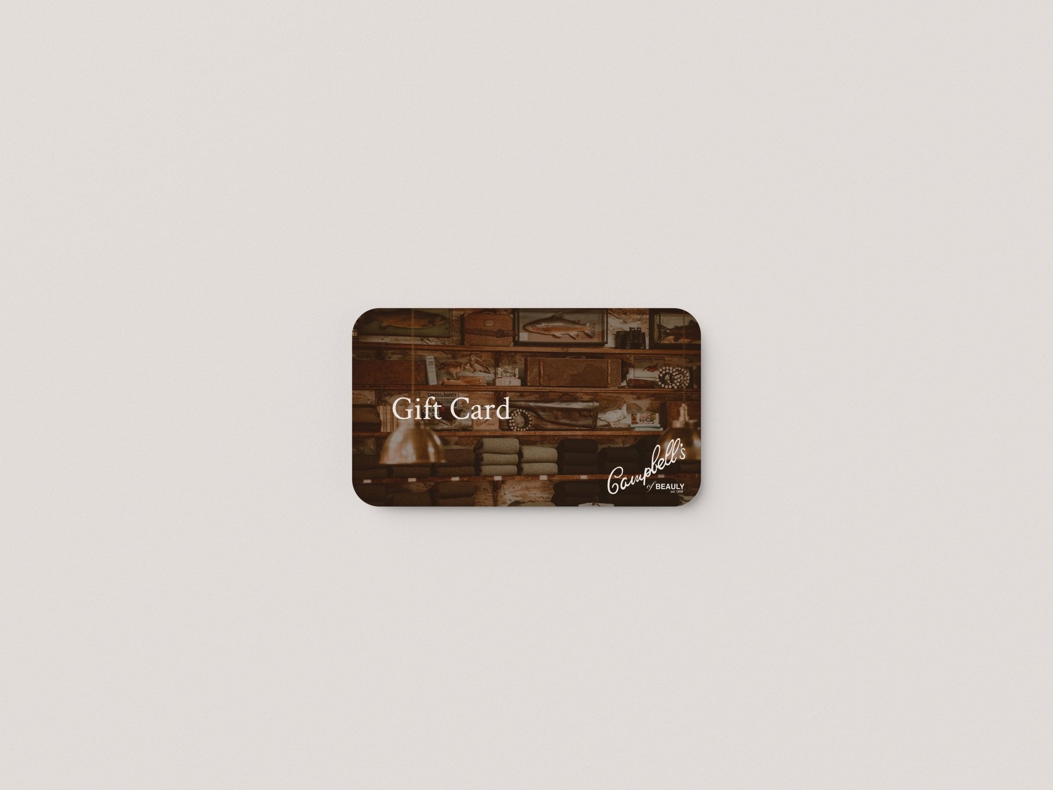 A Campbell’s of Beauly Gift Card with a vintage-inspired design featuring shelves and “Gift Card” on the front sits on a white background—an ideal present for those who appreciate quality cashmere and traditional tweeds.