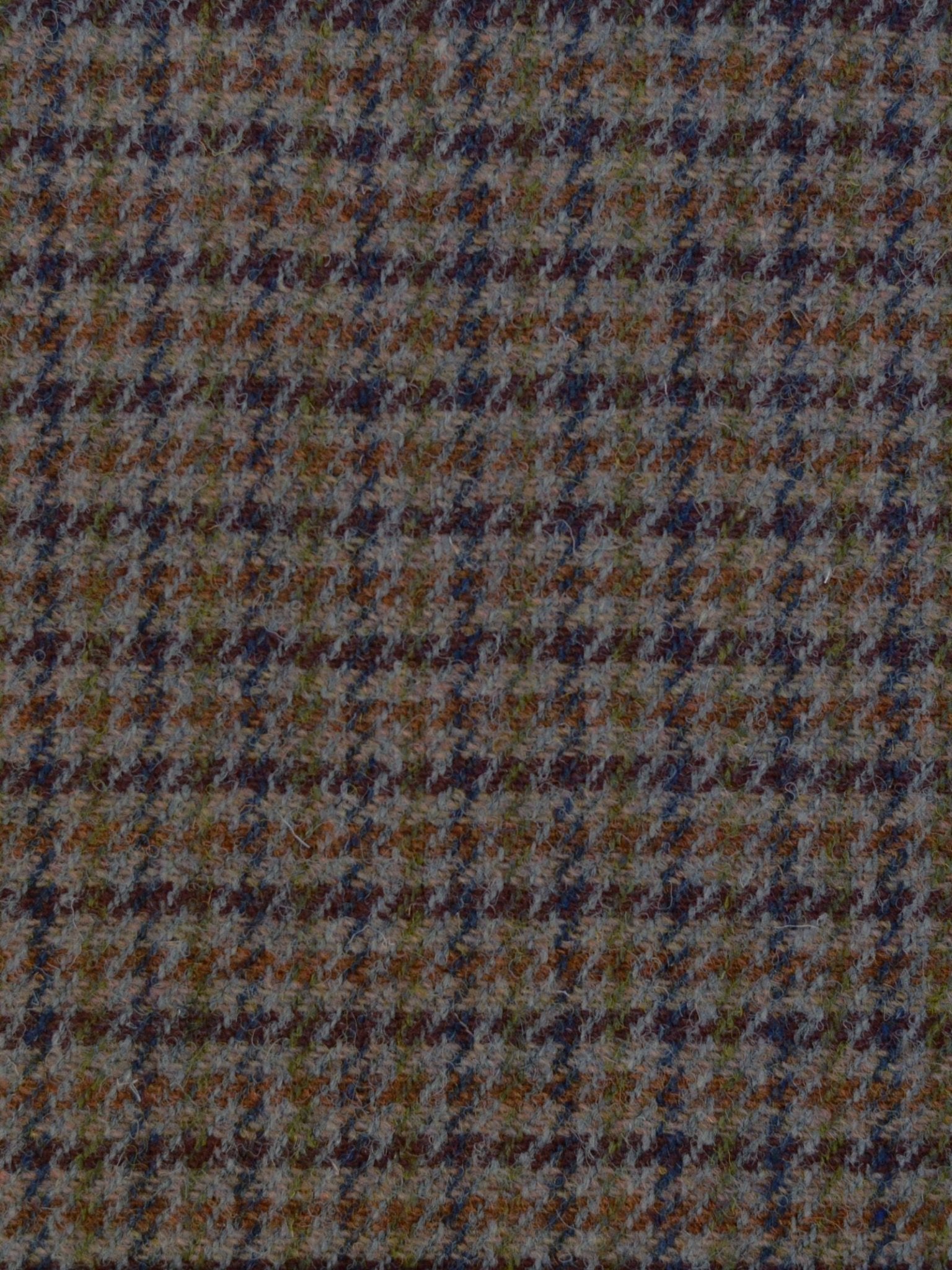 A close-up of Harris Tweed 93914 by Campbell's of Beauly, featuring a brown and blue houndstooth pattern with textured wool and a classic geometric design, reflecting traditional Scottish craftsmanship.