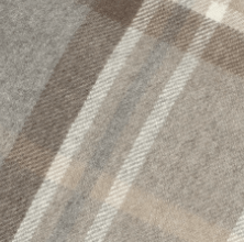 Close-up of the Cashmere Stole by Campbell's of Beauly, featuring a soft plaid fabric in brown, beige, and cream. The fuzzy texture evokes warmth and comfort, echoing the classic appeal of a Scottish wrap.