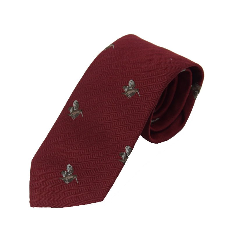 The Woodcock Silk Tie by Campbells of Beauly is a red silk necktie featuring a subtle herringbone pattern and an elegant repeating woodcock motif, offering countryside-inspired refinement.