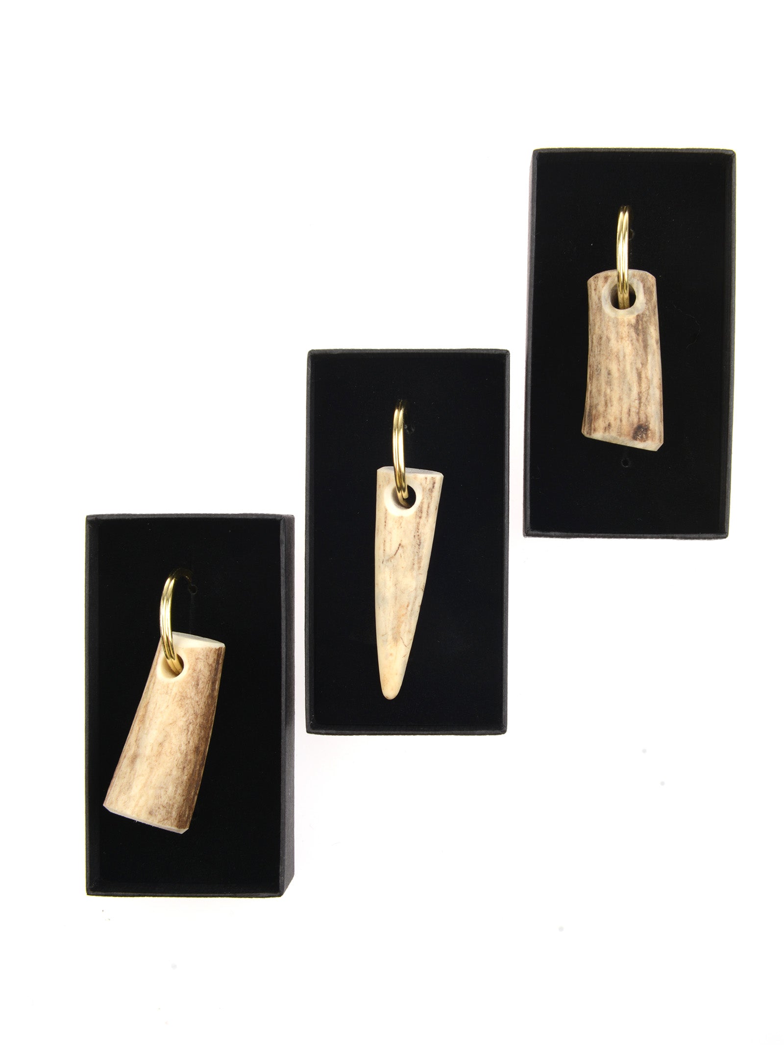 Three rectangular black boxes display Campbell's of Beauly Antler Keyrings, each featuring a gold loop and a polished, natural antler pendant, arranged vertically on a white background.