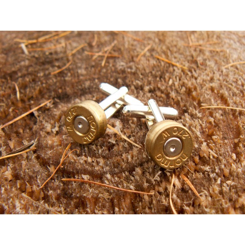 Two Silver-Plated Bullet Cufflinks by Campbells of Beauly rest on a coarse brown fabric with straw-like fibers. The brass casings are engraved with Rottweil and 270 W—ideal for shooting enthusiasts.