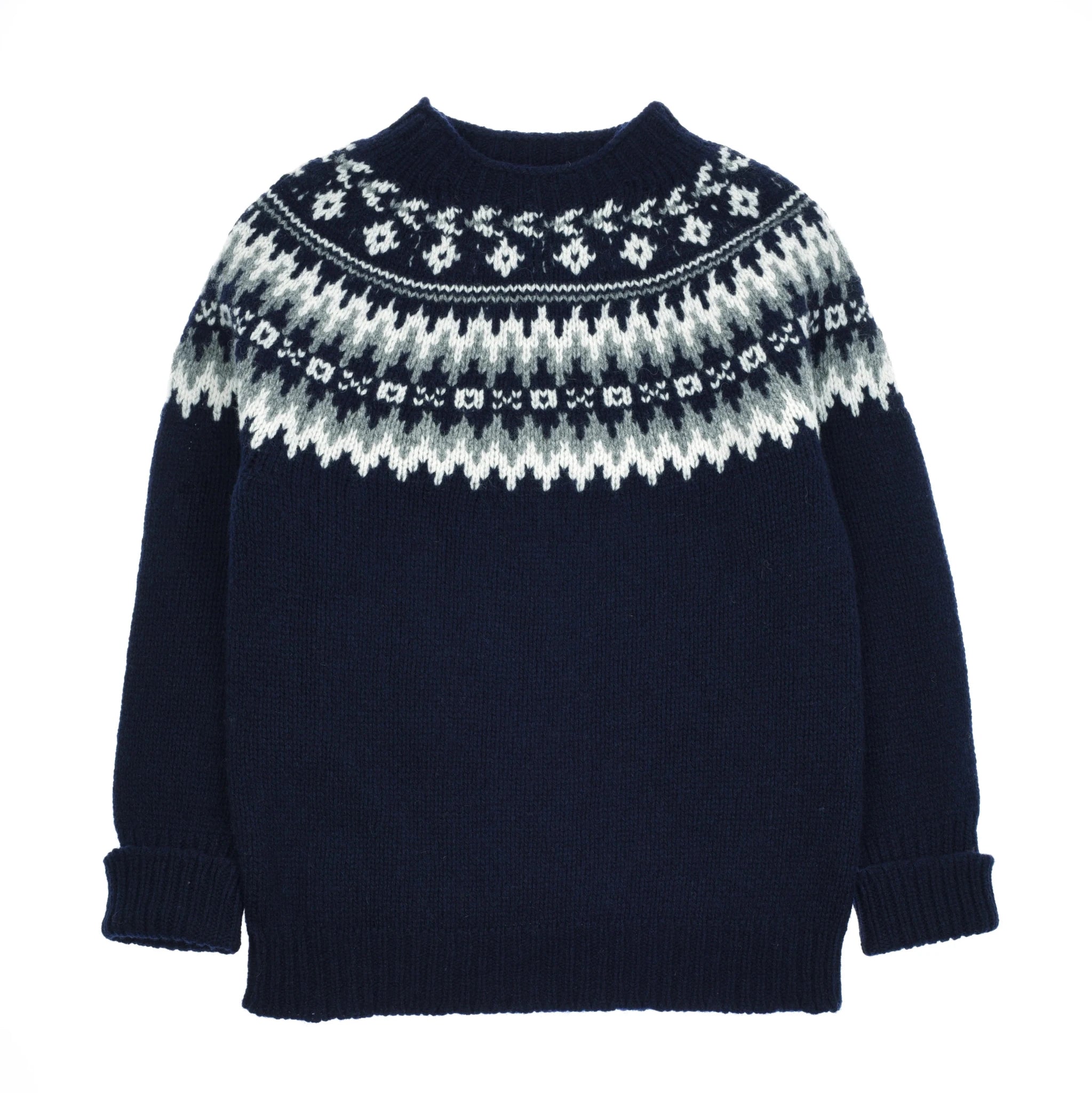 The Auld Stock Chunky Fairisle Jumper by Campbell's of Beauly features a navy blue base with white and light gray geometric patterns on the yoke, long sleeves, and ribbed neckline, cuffs, and hem—a classic winter essential.