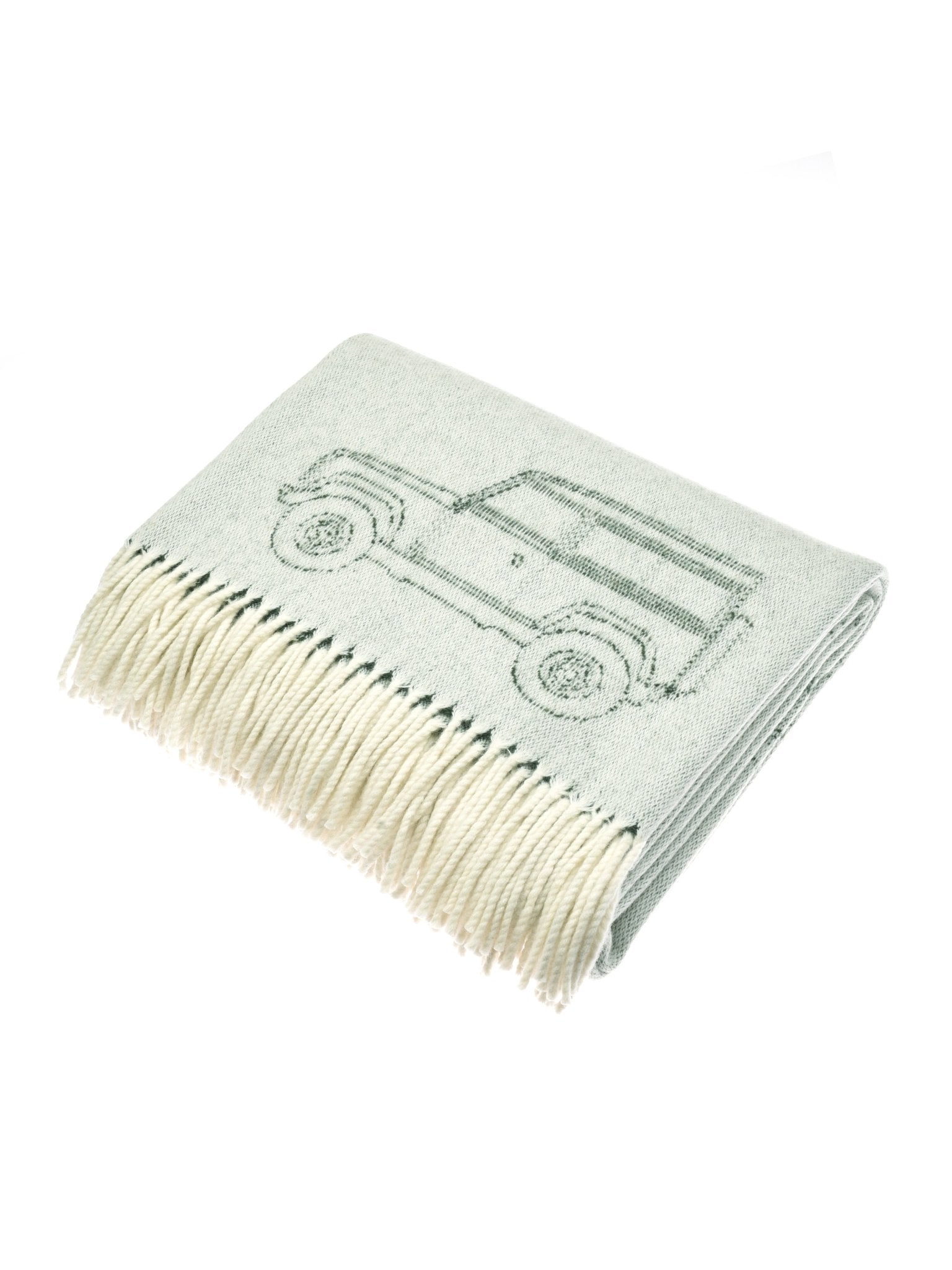 The Campbell’s of Beauly Land Rover Defender Jacquard Throw is a folded light gray wool blanket with cream fringes and a classic SUV outline—ideal for Defender enthusiasts.