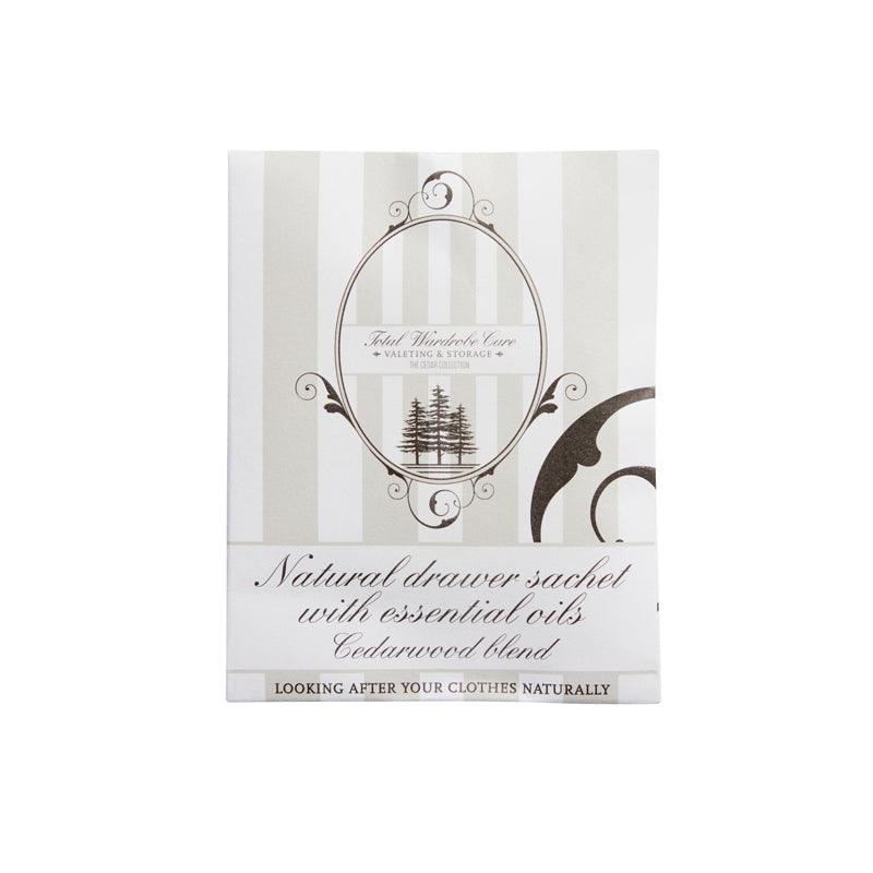 A white and beige striped sachet labeled Anti-Moth Drawer Sachet by Total Wardrobe Care, with a tree logo and decorative swirls, and text at the bottom: Looking after your clothes naturally.