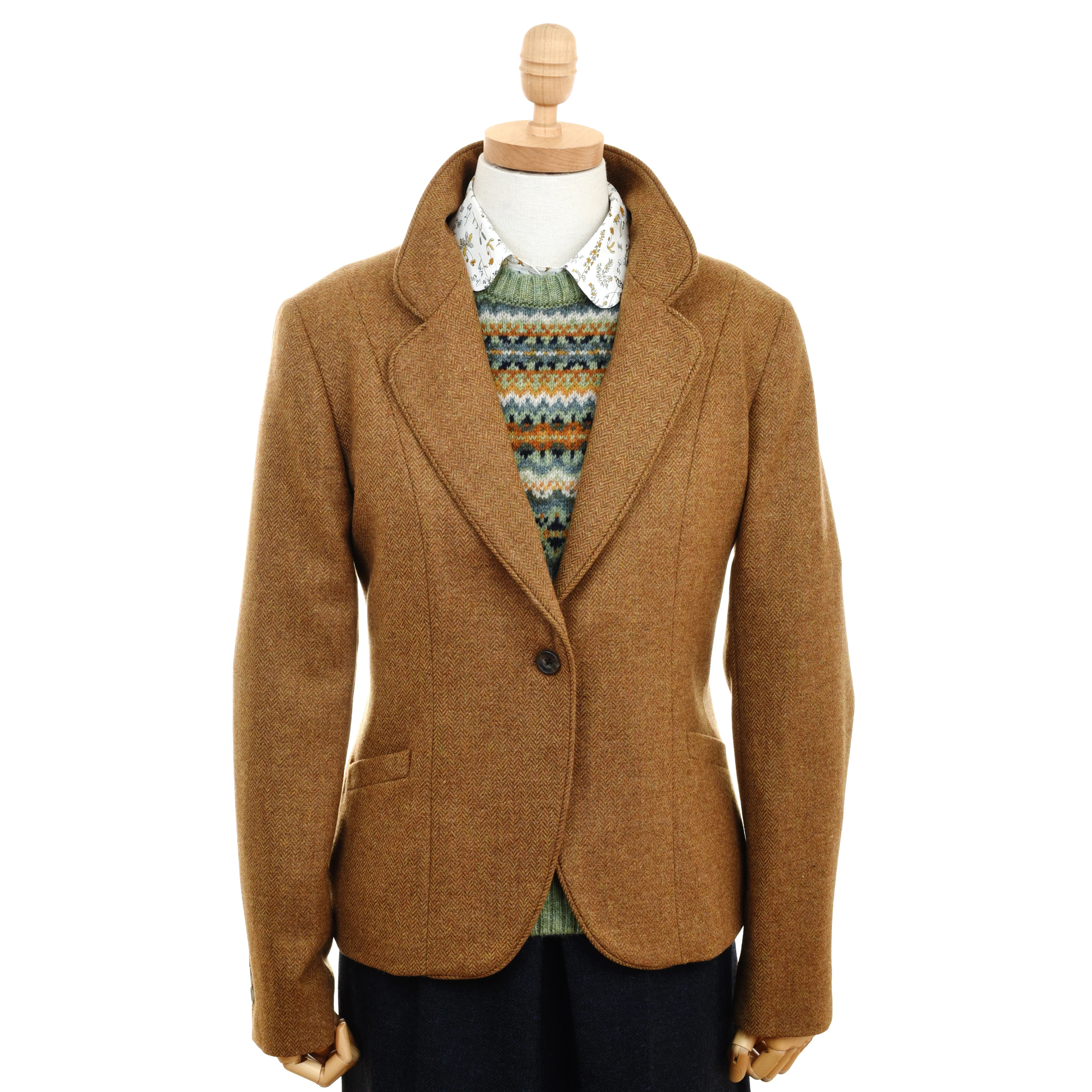A mannequin wears the Campbell's of Beauly Auld Stock House Jacket in brown herringbone over a patterned knit sweater and collared shirt, set against a white background.