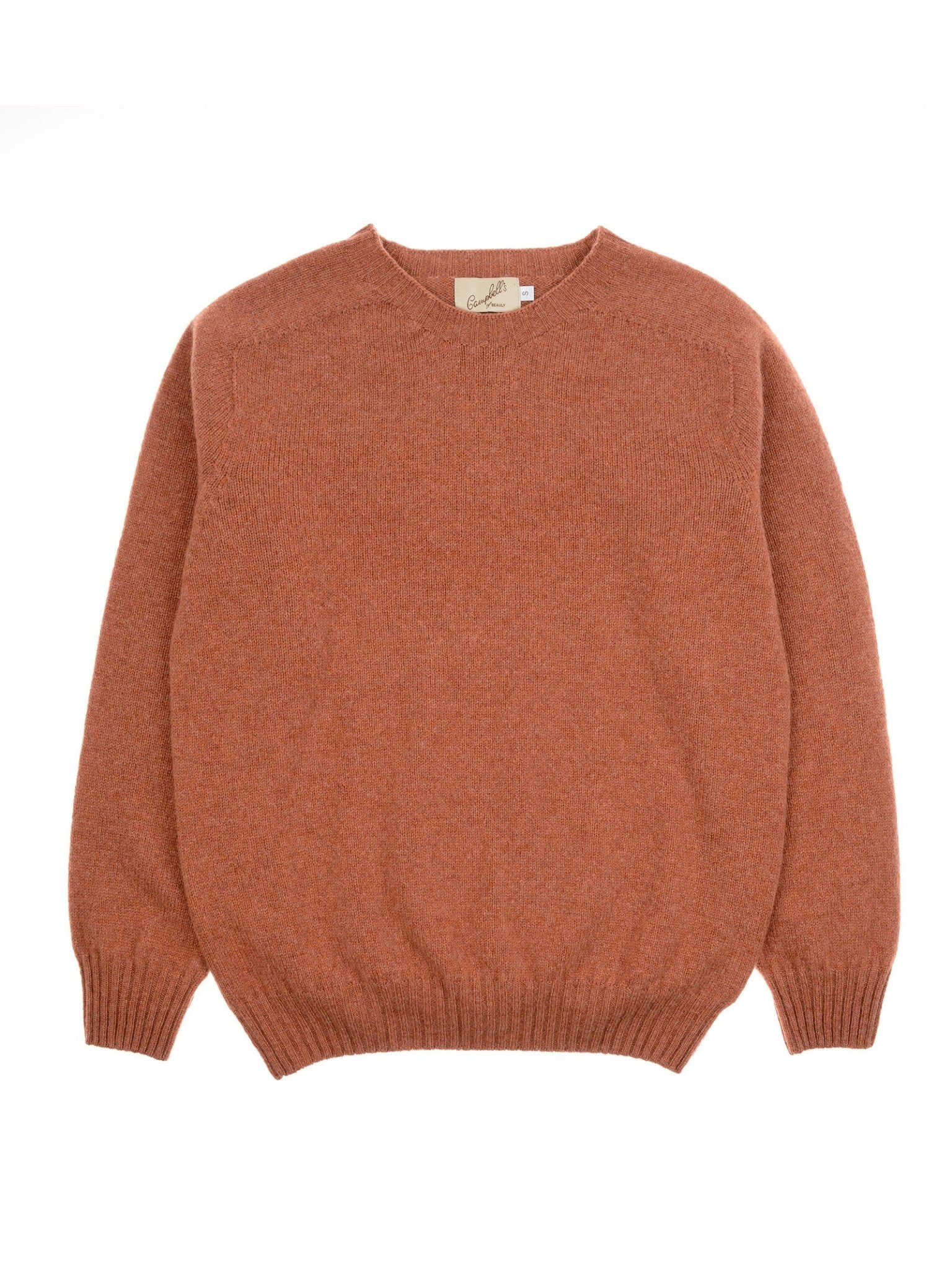 The Campbell's of Beauly Geelong Lambswool Crew Neck Jumper, in rust, is made in Scotland from soft wool. It has long sleeves and ribbed collar, cuffs, and hem, shown laid flat on a white background.