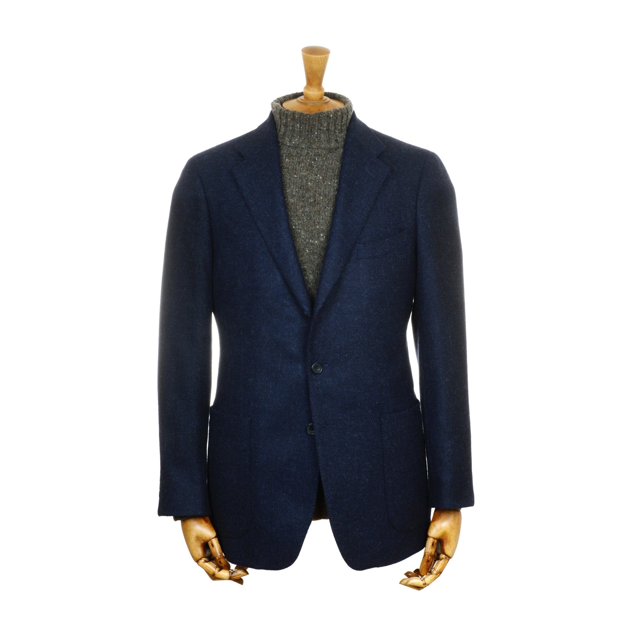The Campbell's House Jacket by Campbell's of Beauly, a navy men's tailored jacket, is displayed on a mannequin with a brown wooden neck and hands, paired with a gray turtleneck sweater against a plain white background.