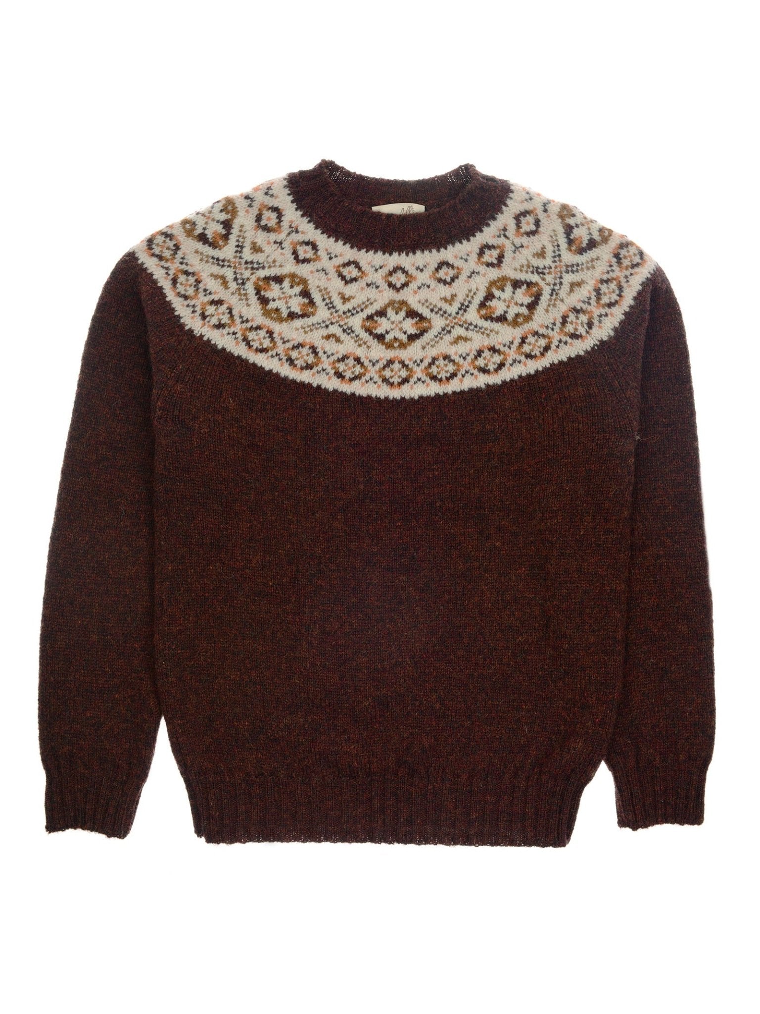 The Campbell's of Beauly Shetland Fairisle Crew is a rust-colored jumper with long sleeves, a crew neck, and white, tan, and blue geometric patterns around the shoulders and upper chest.