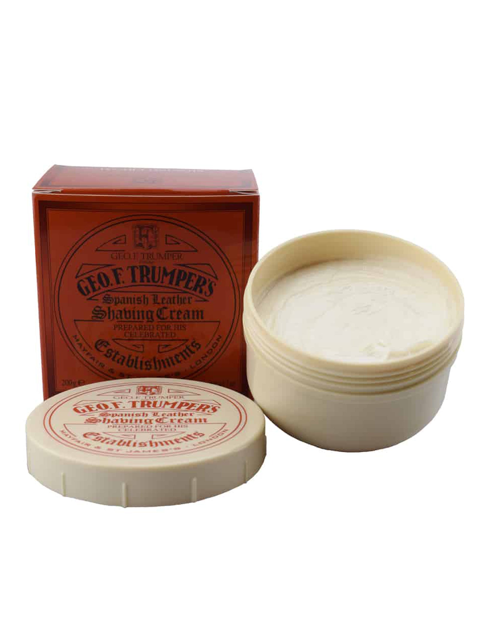 An open 200g tub of Geo. F. Trumper Spanish Leather Shaving Cream sits beside its red box and a shaving brush, revealing the glycerine-based cream inside—perfect for sensitive skin.