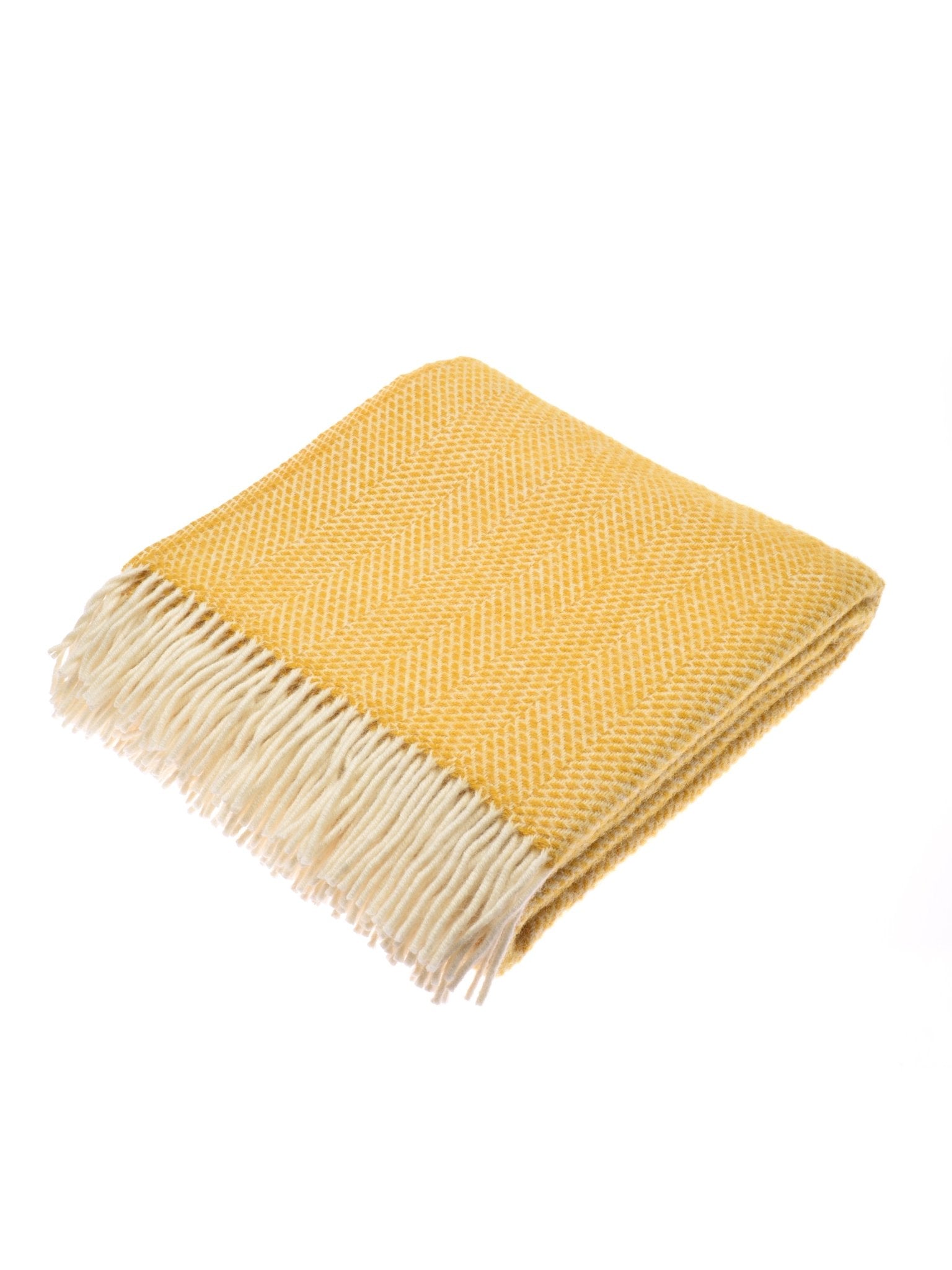The Stipled Twill Blanket by Campbell's of Beauly is a folded yellow wool blanket with a herringbone pattern and white fringe on one end, featuring a breathable weave, displayed on a white background.