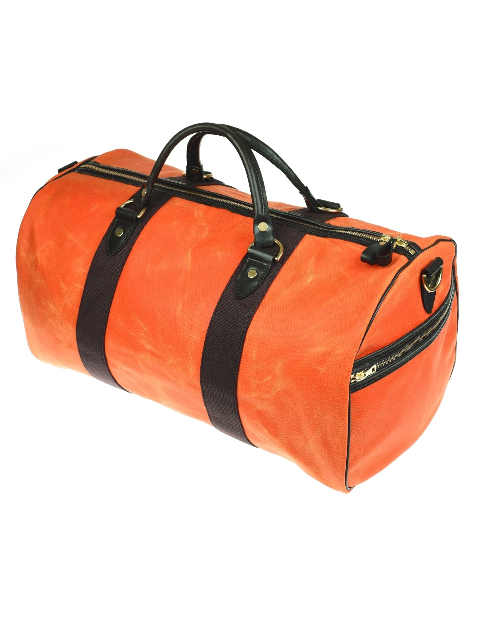 The Wax Holdall by Campbell's of Beauly is a bright orange waxed canvas bag with black bridle leather handles, black straps, and gold zipper accents, shown on a white background.